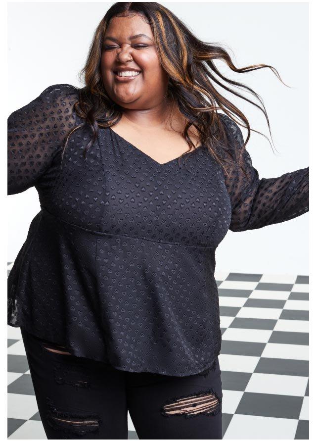 Can you tell me a little bit about what you do at Torrid? I've been with Torrid as a sales associate for seven years. I work normally in the fitting room and that is my happy place. I get to connect with our customers one-on-one. That is where I feel the most efficient, but also my best self. What's your favorite part about working at Torrid? Definitely the fitting room interactions. I've had so many opportunities to meet so many different women. And hearing their stories and what they're coming in for is an amazing opportunity. It gives me butterflies just thinking about it. How has your store team been supporting you through #TeamTorrid? The support that I'm receiving from my team has just been phenomenal. My manager, Adriana, literally everyday was like, “Did you submit your application?” … Just pressing me on it. I appreciated that because I was so nervous to do it because you get in your head about it … And yes, “Procrastination” is my middle name. I waited till the last day, but we got it done. How did you find out about Torrid? I was walking down a little mall hallway and I saw a sign saying that Torrid was coming. So I had immediately looked it up and was scrolling through and I was like, “Oh my God. Oh my God. The clothing here is amazing. It's beautiful. And it's for me.” Being able to see a store that accommodates my size, my shape, my little bit of weirdness … Being able to see a store that was able to provide all of that? Game-changing. What does being part of #TeamTorrid mean to you? What it means to me to be #TeamTorrid is being fearlessly unapologetic, because we're in an industry where you're always being criticized for what you're wearing, and I refuse to allow anyone to dictate or determine how I see myself as beautiful.