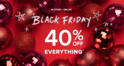 Red holiday-themed background with decorative ornaments surrounding the text 'Black Friday 40% Off Everything*' in bold white font. The phrase 'In Store + Online' is displayed above the main text.