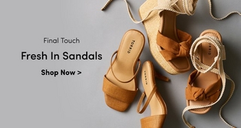 Flat lay of four pairs of tan and brown Torrid brand sandals on a gray background. Text reads Final Touch. Fresh In Sandals. Shop Now.