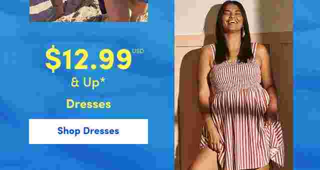 Smiling woman in a red and white striped sleeveless dress standing indoors with sunlight casting shadows. Overlaid text reads 12.99 USD and up, Dresses.