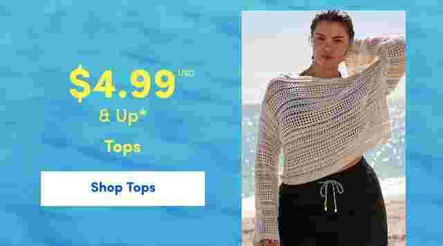 Woman standing on a beach wearing a white open-knit sweater and black drawstring shorts. Overlaid text reads 4.99 USD and up, Tops. Ocean background with bright blue water.