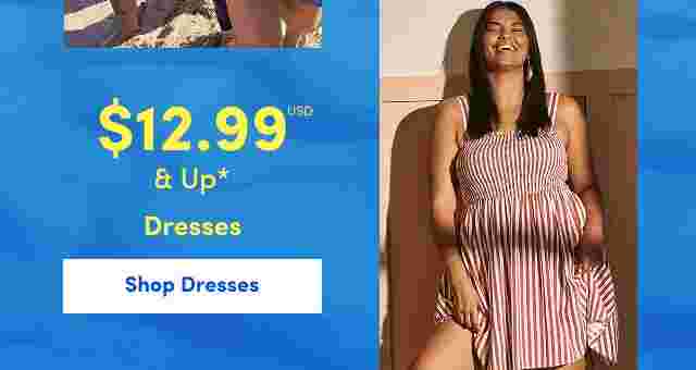 Smiling woman in a red and white striped sleeveless dress standing indoors with sunlight casting shadows. Overlaid text reads 12.99 USD and up, Dresses.