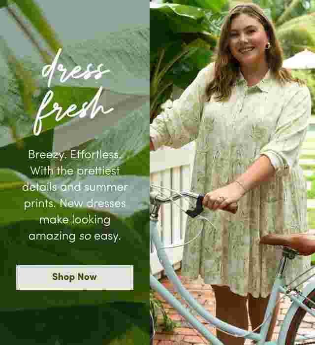 Two women wearing light, floral-patterned summer dresses. One stands in front of a white picket fence holding a pink handbag, the other poses with a bicycle near a pool. Text reads Dress Fresh with a description of breezy, effortless new summer styles and a Shop Now button.