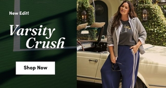 model wearing a casual varsity inspired outfit including a gray jacket over a graphic tee and navy track pants with side stripes leaning against a cream convertible parked in front of a building surrounded by greenery text reads new edit varsity crush shop now