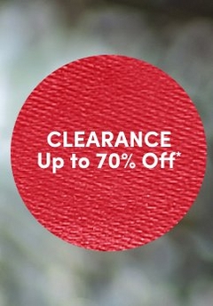 'Red circular badge with a subtle textured fabric-like surface and white centered text that reads CLEARANCE Up to 70% Off*, set against a softly blurred gray and green background.'