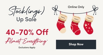 'Light beige background with left text in black and red; top black script reads Stock(ings) with black text below reading Up Sale; large red text reads 40–70% Off; red script below reads Almost Everything* with small black text Exclusions Apply; on the right three red holiday stockings hang from a black ribbon bow line, each cuff labeled TORRID; small black text above the stockings reads Online Only; below the stockings a dark blue rectangular button with white text reads Shop Now.'