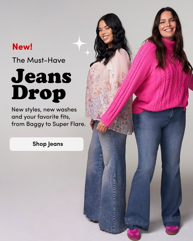 'A studio image shows three women wearing different styles of blue jeans against a light gray background. On the left, a woman with long black hair smiles while wearing a black leather jacket over a black corset-style top and light-wash wide-leg jeans with distressed knees and black heels. On the right, two women stand side by side: one wears a sheer light pink floral blouse with mid-wash flare jeans, and the other wears a bright pink cable-knit sweater with dark-wash flare jeans and pink shoes. Black and red text centered between them reads New! The Must-Have Jeans Drop. Smaller black text below reads New styles, new washes and your favorite fits, from Baggy to Super Flare. A rounded light beige button below reads Shop Jeans.'