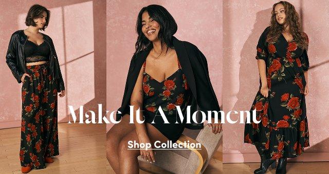 Three women posing against a textured pink wall modeling pieces from a black clothing collection with a red rose print. On the left a model wears floral wide-leg pants and a leather jacket, in the center a model sits wearing a floral camisole and black blazer, and on the right a model stands in a long floral dress. Overlay text reads: Make It A Moment Shop Collection