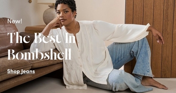 Woman models a white oversized blouse with light wash jeans while seated on the floor beside a leather sofa. Text reads New The Best Bombshell Shop Jeans.
