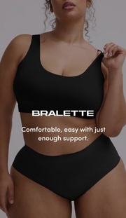Model shown from chin to mid-thigh against a light gray background, wearing a black scoop-neck bralette with wide straps and smooth fabric, paired with matching black high-waisted briefs. Model has curly brown hair visible at shoulders, one arm raised with hand near shoulder and white nail polish visible. White text overlay reads 'BRALETTE' with subtext below reading 'Comfortable, easy with just enough support.'