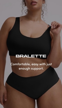 Model shown from chin to mid-thigh against a light gray background, wearing a black scoop-neck bralette with wide straps and smooth fabric, paired with matching black high-waisted briefs. Model has curly brown hair visible at shoulders, one arm raised with hand near shoulder and white nail polish visible. White text overlay reads 'BRALETTE' with subtext below reading 'Comfortable, easy with just enough support.'