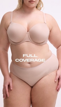 Model shown from chin to upper thigh against a light gray background, wearing a nude beige strapless bra with molded cups, side boning, and a sweetheart neckline, paired with matching nude beige high-waisted shaping briefs with a smooth waistband. Model has blonde wavy hair visible at shoulders. White text overlay reads 'FULL COVERAGE' across the midsection.