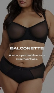 Model shown from chin to mid-thigh against a light gray background, wearing a black sheer mesh balconette bra with underwire and visible seaming, paired with black sheer mesh cheeky panties with a small bow at center front. Model has long dark wavy hair and a floral tattoo sleeve visible on left forearm. White text overlay reads 'BALCONETTE' with subtext below reading 'A wide, open neckline for a sweetheart look.'