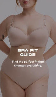 Model shown from chin to upper thigh against a gray background, wearing a nude beige wireless bra with smooth molded cups and wide adjustable straps, paired with matching nude beige high-waisted shaping briefs. Model has strawberry blonde hair and a small tattoo visible on her upper right arm, with hands on hips. White text overlay reads 'BRA FIT GUIDE' with subtext below reading 'Find the perfect fit that changes everything.' with 'everything' in italics.