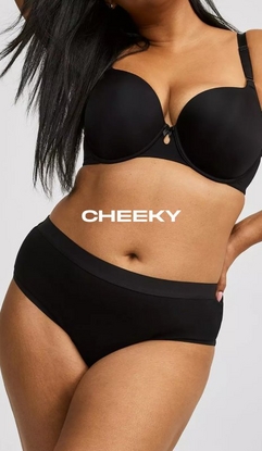 Model shown from neck to upper thighs against a light gray background, wearing a black t-shirt bra with molded cups, adjustable straps, and a small keyhole detail at center gore, paired with black cheeky panties with a wide smooth waistband. Model has long straight black hair falling over one shoulder and one hand resting on hip with pink nail polish visible. White text overlay reads 'CHEEKY' across the midsection.