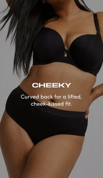 Model shown from neck to upper thighs against a light gray background, wearing a black t-shirt bra with molded cups, adjustable straps, and a small keyhole detail at center gore, paired with black cheeky panties with a wide smooth waistband. Model has long straight black hair falling over one shoulder and one hand resting on hip with pink nail polish visible. White text overlay reads 'CHEEKY' with subtext below reading 'Curved back for a lifted, cheek-kissed fit.'