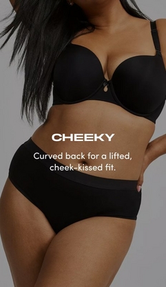 Model shown from neck to upper thighs against a light gray background, wearing a black t-shirt bra with molded cups, adjustable straps, and a small keyhole detail at center gore, paired with black cheeky panties with a wide smooth waistband. Model has long straight black hair falling over one shoulder and one hand resting on hip with pink nail polish visible. White text overlay reads 'CHEEKY' with subtext below reading 'Curved back for a lifted, cheek-kissed fit.'