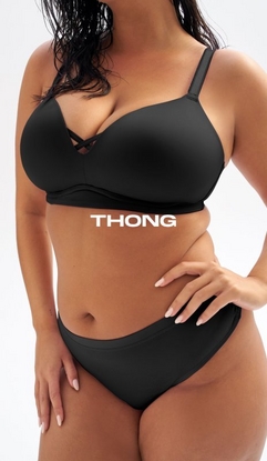 Model shown from neck to upper thighs against a light gray background, wearing a black wire-free plunge bra with smooth cups, wide band, and crisscross strap detail at center front, paired with a black thong with a smooth waistband. Model has long dark wet-look hair and one hand resting on hip with nude nail polish visible. White text overlay reads 'THONG' across the midsection.