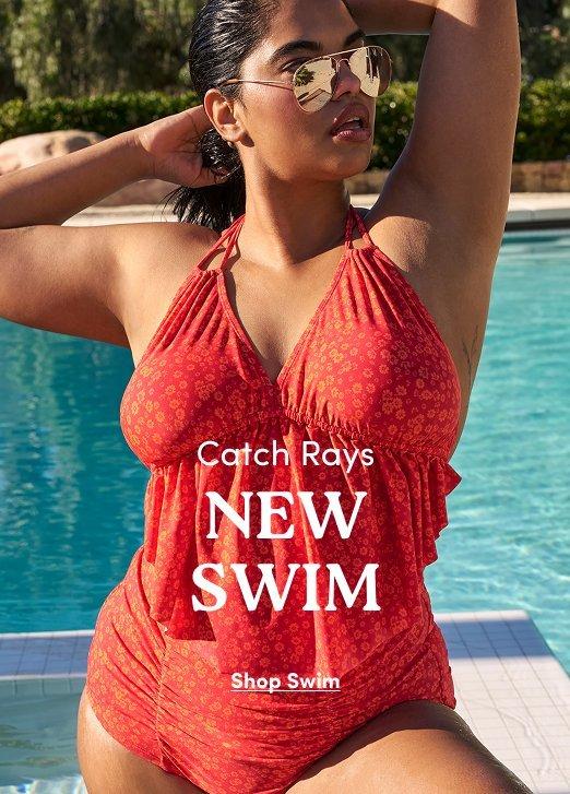 "Torrid New Swim advertisement: Model in a red floral ruffled tankini posing by a pool. Text: Catch Rays NEW SWIM. Shop Swim."