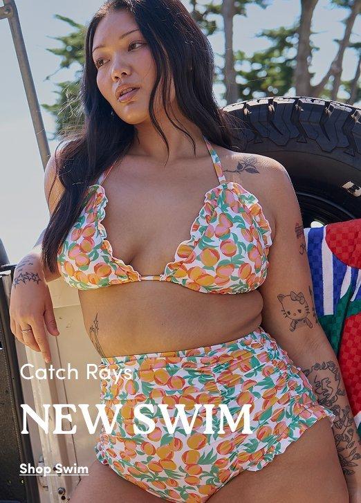 Torrid New Swim advertisement: Model in a ruffled triangle bikini with a peach print. Text: Catch Rays NEW SWIM. Shop Swim.