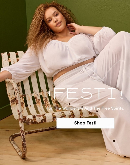 A promotional banner for 'Festi™' with the tagline 'For The Wanderers And The Free Spirits.' and a white 'Shop Festi' button overlaid on a photo. A woman with voluminous curly light brown hair reclines on a vintage distressed white metal slatted outdoor chair against a dark olive green wall with light wood flooring. She wears a white long-sleeve cropped peasant-style top with a gathered square neckline paired with white wide-leg drawstring trousers.