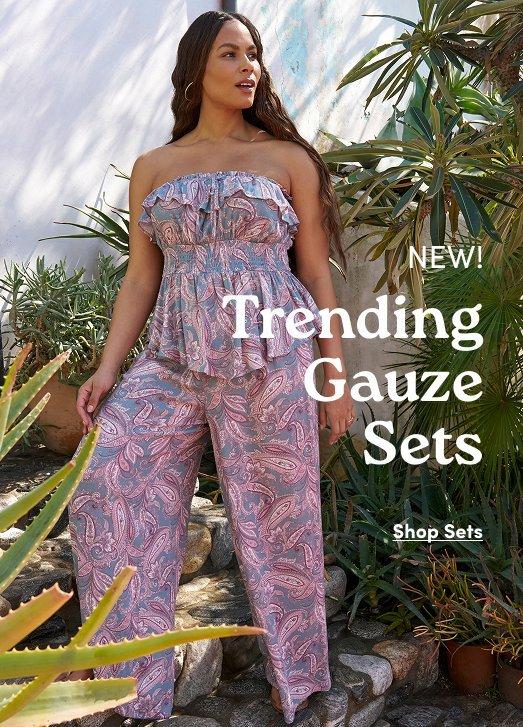 Model in a strapless paisley peplum top and matching pants. Text: NEW! Trending Gauze Sets.