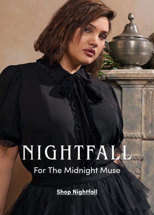 "Nightfall collection advertisement: Model wears a black short-sleeved blouse with ruffled trim, lace sleeves, and a velvet tie at the neck, paired with a black tiered tulle skirt. Text: NIGHTFALL For The Midnight Muse. Shop Nightfall."