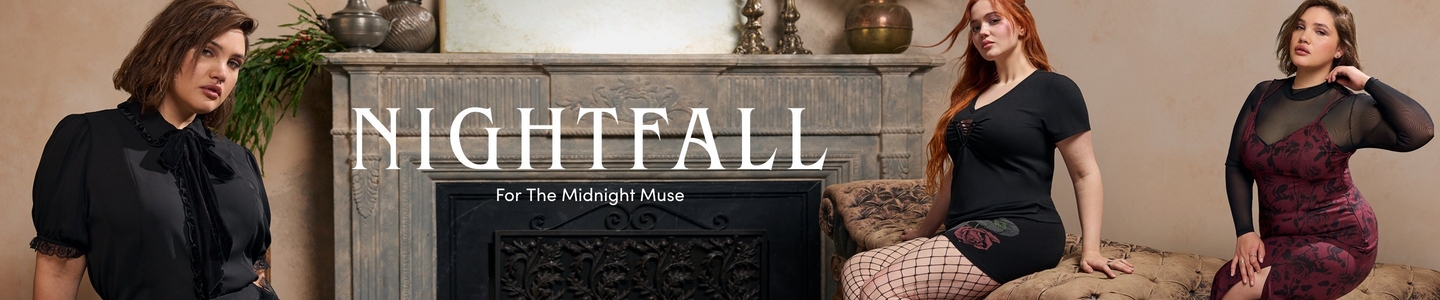 A promotional banner for 'Nightfall' with the tagline 'For The Midnight Muse' in white text, set against a moody warm beige interior with an ornate stone fireplace, decorative bronze vessels, greenery, and a tufted antique sofa. Three women are shown across the banner. On the left, a woman with short dark brown wavy hair and a nose ring stands wearing a black short-sleeve blouse with puff sleeves, a ruffled bib front, velvet bow tie at the neck, and lace cuff detail. In the center, a woman with long red hair sits on the tufted sofa wearing a black short-sleeve fitted top with a lace-up bust detail and a black mini skirt, with black fishnet tights. On the right, a woman with dark hair pulled back and one hand raised to her neck wears a long-sleeve sheer black mesh top layered over a dark burgundy floral jacquard midi dress.