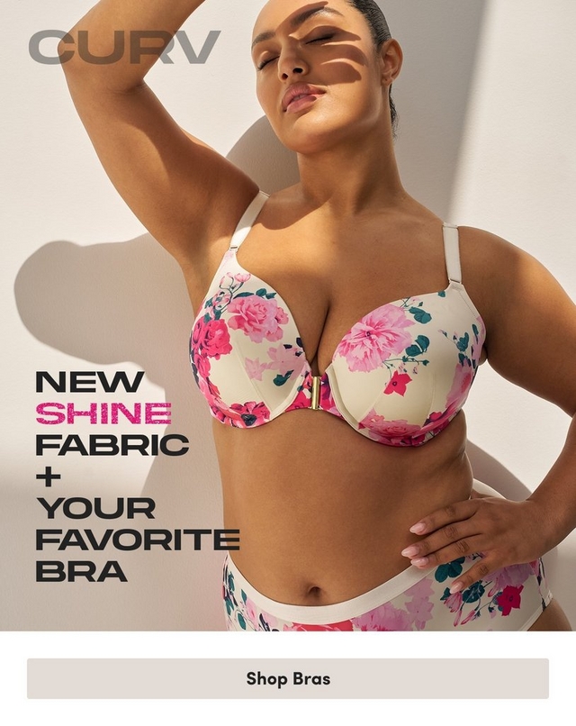 ''Promotional banner for Torrid CURV on a light beige background with soft angular shadow shapes. A plus-size woman with medium skin tone and dark hair pulled back poses with one arm raised above her head and the other hand on her hip, eyes closed and face tilted upward. She is wearing a cream-colored bra and high-waist briefs with a pink, red, and teal floral print, and a gold front clasp detail on the bra. In the upper left corner, gray text reads 'CURV'. On the lower left, bold dark text reads 'NEW' with 'SHINE' in bold pink on the next line, followed by 'FABRIC + YOUR FAVORITE BRA' in bold dark text on separate lines. At the bottom is a light gray rectangular button with bold dark text reading 'Shop Bras'.'