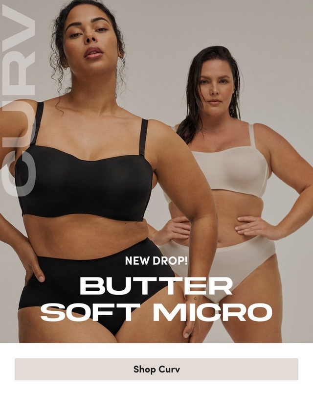 'Promotional banner for Torrid CURV featuring the Butter Soft Micro collection against a light gray background. Two plus-size women stand together. In the foreground, a woman with medium skin tone and dark curly hair pulled up looks directly at the camera with a serious expression, one hand on her hip, wearing a black bandeau-style bra and matching high-waist bikini briefs. Behind her, a woman with light skin tone and dark hair pulled back stands with one hand on her hip, wearing a cream square-neck crop bra top and matching high-waist briefs. Partially visible white text on the left edge reads 'CURV'. Overlaid across the lower portion, small white text reads 'NEW DROP!' above large bold white text reading 'BUTTER SOFT MICRO'. At the bottom is a light beige rectangular button with dark text reading 'Shop Curv'.'
