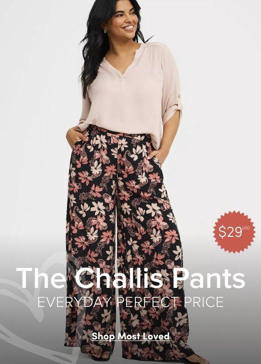 Woman wearing a light neutral blouse with black floral challis wide leg pants. Image text reads The Challis Pants, Everyday Perfect Price, $29 USD, Shop Most Love
