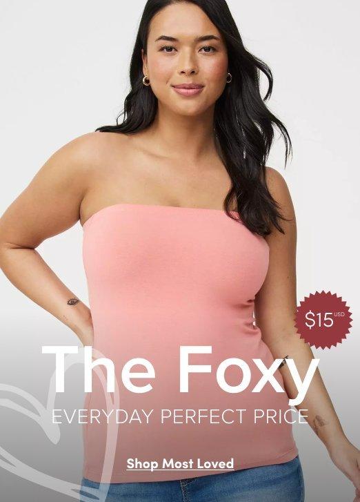 2:23 PMClaude responded: A promotional banner with a light gray background.A promotional banner with a light gray background. A woman with long dark hair and small stud earrings is shown from the waist up, looking directly at the camera with a slight smile. She wears a strapless ribbed tube top in dusty rose pink. A red circular badge in the upper right reads '$15' with a superscript asterisk. Overlaid white text in the lower portion reads 'The Foxy' in large letters, with 'EVERYDAY PERFECT PRICE' in smaller text below it. At the bottom is a white rectangular button with dark text reading 'Shop Most Loved'.