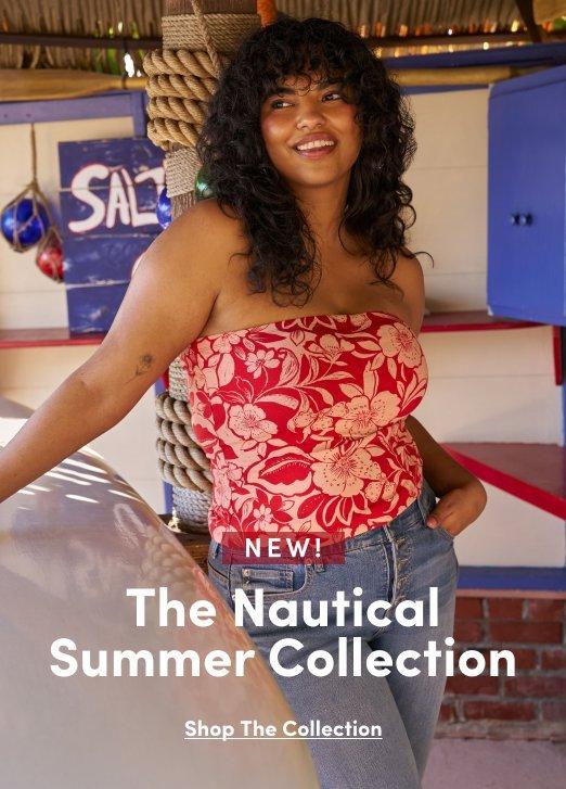 2:18 PM'Promotional banner for Torrid featuring the Nautical Summer Collection. A plus-size woman with medium skin tone and long dark curly hair smiles warmly, leaning against a white and red painted wooden surface in what appears to be a seaside shack or beach hut setting, with a partially visible sign reading 'SAL' and hanging decorative buoys visible in the background. She is wearing a red and white tropical floral print strapless tube top and light wash wide-leg jeans, with small earrings. A small white rounded badge reads 'NEW!' above white serif text reading 'The Nautical Summer Collection'. Below that, small dark underlined text reads 'Shop The Collection'.'