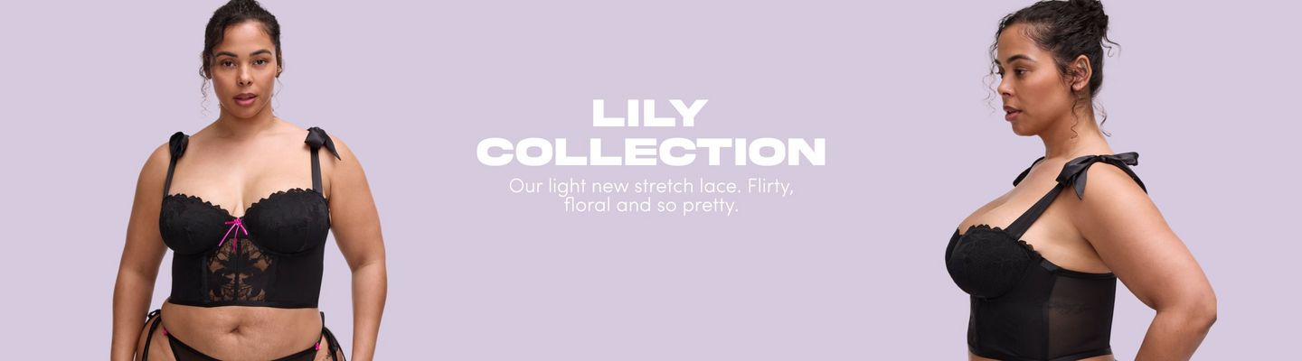 'A wide promotional banner for the Lily Collection featuring the same plus-size woman with dark hair pulled up in a loose bun shown from two angles against a soft lavender background. On the left, she faces forward wearing a black stretch lace longline strapless bra with scalloped trim along the upper cups, a small hot pink bow at the center front, wide tie straps with black satin bow detail at the shoulders, and a sheer lace panel below the bust. A black lace thong with hot pink bow detail is partially visible at the bottom. On the right, the same woman is shown in profile facing right, wearing the same bra. Bold white text in the center reads 'LILY COLLECTION' with smaller white text below reading 'Our light new stretch lace. Flirty, floral and so pretty.''
