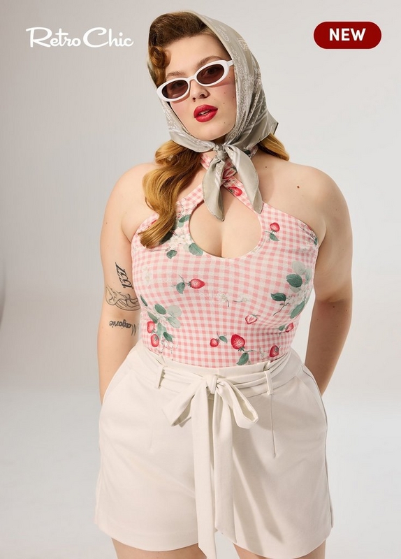 'A plus-size woman with auburn hair styled in vintage victory rolls poses against a light gray background. She wears white oval-frame sunglasses with tinted lenses, a sage green and white floral paisley headscarf tied loosely at the neck, and a pink gingham halter bodysuit with a strawberry and floral print and a keyhole cutout at the neckline. She is paired with high-waist cream shorts with a self-tie bow at the waist. She has tattoos visible on her left upper arm and forearm. White script text in the upper left reads 'Retro Chic' and a dark red rounded badge in the upper right reads 'NEW' in white text.'