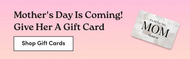 'A horizontal banner with a soft pink to peach gradient background. On the left, dark bold serif text reads 'Mother's Day Is Coming! Give Her A Gift Card'. Below the text, a white rectangle button with a dark border contains bold dark text reading 'Shop Gift Cards'. On the right, a slightly tilted gift card is displayed with a white floral background design, small text reading 'It's All For You', large bold text reading 'MOM', and the Torrid logo below.'