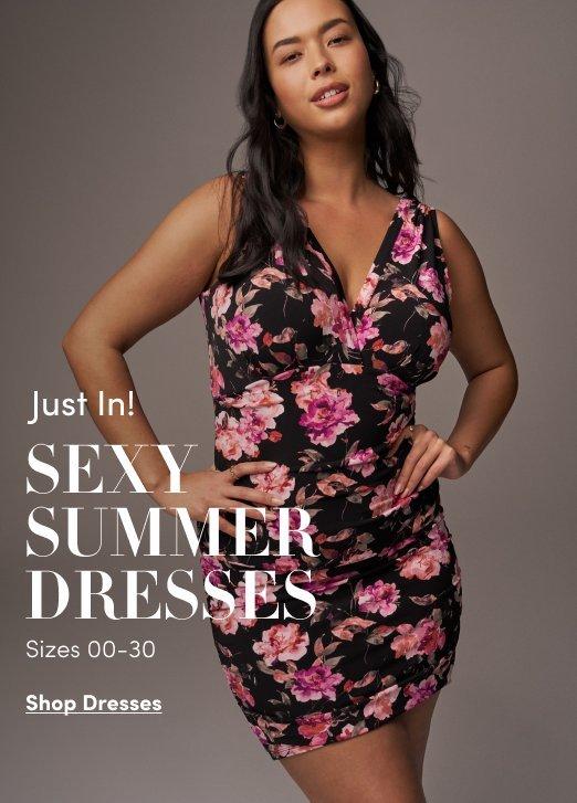 A woman poses in a black V-neck mini dress with a pink and purple floral pattern. White text on the left reads "Just In! SEXY SUMMER DRESSES. Sizes 00-30." At the bottom is a "Shop Dresses" link.