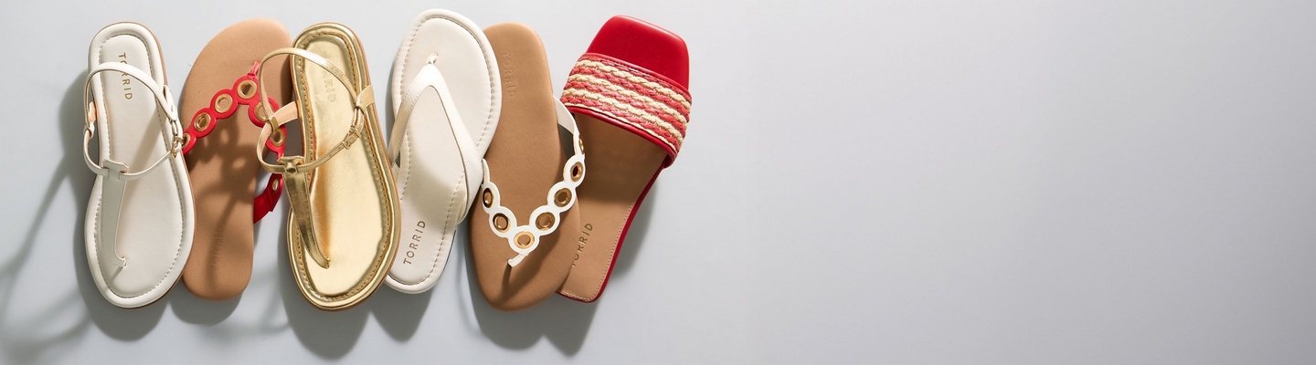 A wide promotional banner featuring a row of six various summer sandals arranged against a light grey background. The footwear includes white T-strap sandals, tan sandals with red and gold ring details, gold metallic strappy sandals, white thong flip-flops, tan flip-flops with gold eyelet-accented straps, and red slide sandals with a woven strap.