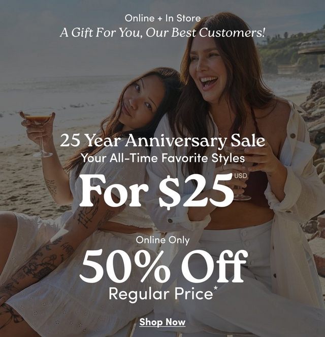 A square promotional banner with the same darkened beach scene background showing the same two women more prominently, both with long dark hair wearing white outfits, one holding a drink with extensive arm tattoos visible, the other laughing with her arm around the first. Rocky cliffs with greenery are visible in the background. White text at the top reads 'Online + In Store' and 'A Gift For You, Our Best Customers!' in italic script. Centered white text reads '25 Year Anniversary Sale', 'Your All-Time Favorite Styles', then large bold text reading 'For $25 USD', followed by 'Online Only', '50% Off', and 'Regular Price*'. At the bottom center is underlined white text reading 'Shop Now'.