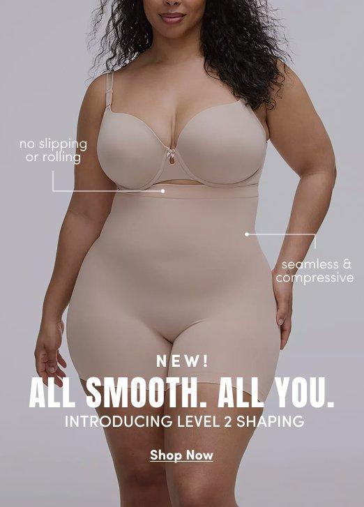 Promotional image featuring a model wearing nude shaping shorts and a matching bra against a light gray background. Callout text highlights “no slipping or rolling” and “seamless & compressive.” Main text reads “NEW! ALL SMOOTH. ALL YOU. INTRODUCING LEVEL 2 SHAPING” with “Shop Now” below.