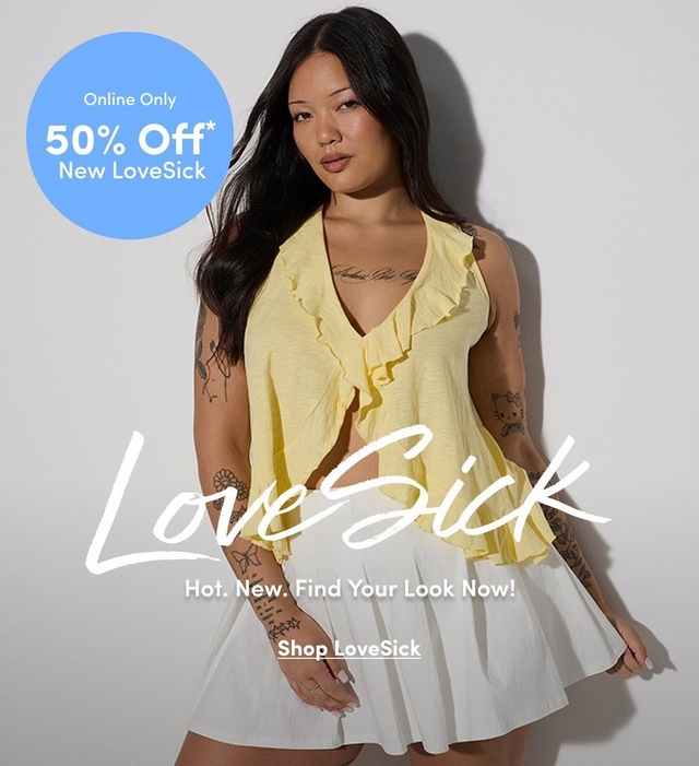 A promotional banner featuring a woman with long straight dark hair wearing a pale yellow sleeveless ruffle-front crop top with a V-neckline and a white pleated mini skirt. She has extensive tattoos on both arms and her chest and wears a ring on one finger. The background is a plain off-white wall with soft shadow. A light blue circle badge in the upper left reads 'Online Only 50% Off* New LoveSick' in white text. Large white script text across the center reads 'LoveSick' followed by smaller white text reading 'Hot. New. Find Your Look Now!' and an underlined link reading 'Shop LoveSick.'