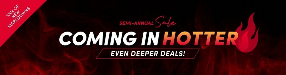 A wide promotional banner with a dark background featuring a red flame and smoke graphic. A red triangular badge in the upper left reads '100s OF NEW MARKDOWNS' in white text. Center text reads 'SEMI-ANNUAL Sale' in white and red script, followed by large bold text reading 'COMING IN HOTTER' in white and orange, with a flame emoji graphic, and a red-outlined box reading 'EVEN DEEPER DEALS!' in white.