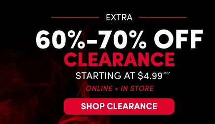 A wide promotional banner with a dark background and red smoke graphic. White text reads 'EXTRA' followed by large white text reading '60%-70%' and large red text reading 'CLEARANCE' with white text below reading 'STARTING AT $4.99 USD*' A red-outlined rectangular badge reads '100s OF NEW MARKDOWNS' and a white text link reads 'SHOP CLEARANCE >' A white circle badge in the upper right reads 'ONLINE + IN STORE EARN 3X TORRID CASH**'