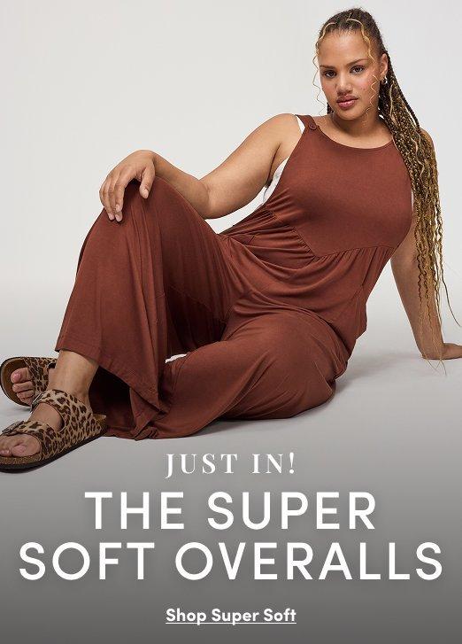 A model wears a brown sleeveless soft overall jumpsuit with leopard print sandals. Text reads, “Just In! The Super Soft Overalls. Shop Super Soft.”