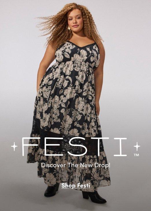 A woman models a black floral maxi dress with a high-low hem and black boots against a gray studio backdrop. Text reads, “Festi. Discover The New Drop! Shop Festi.”
