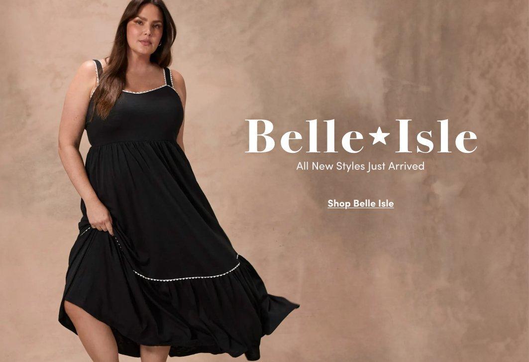 A promotional banner with a warm beige and brown textured background. A woman with long dark hair stands posed with one hand on her hip, wearing a black sleeveless midi dress with thin spaghetti straps, a tiered skirt, and white trim detail at the hem. White text to the right reads 'Belle*Isle' with smaller text below reading 'All New Styles Just Arrived' and an underlined link reading 'Shop Belle Isle.'