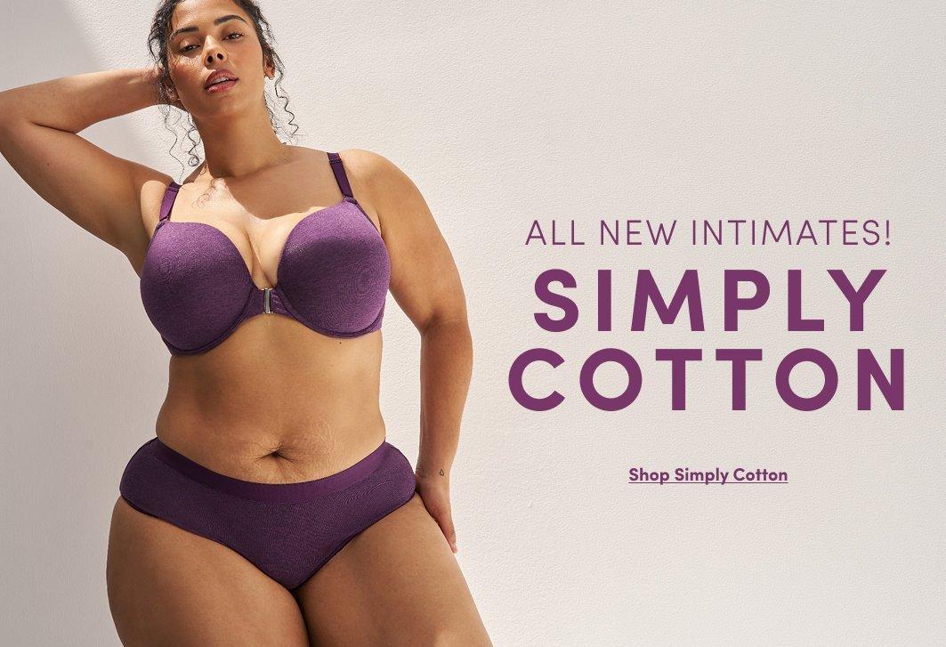 A promotional banner with a light pink-beige background. A woman with long dark wavy hair stands with one hand on her hip, wearing long dangling earrings and a deep purple push-up bra with underwire and matching high-waist bikini-cut panties. Text to the right reads 'ALL NEW INTIMATES!' in small dark text and 'SIMPLY COTTON' in large bold purple text, with an underlined link reading 'Shop Simply Cotton.'