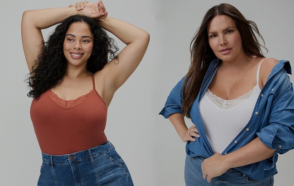 Split image on a plain light gray background. On the left, a woman with long dark curly hair smiles with her arms raised above her head, resting her wrists together. She wears a rust orange cami top with a lace trimmed v-neckline and thin straps, paired with denim jeans. On the right, a woman with long dark hair stands with one hand on her hip, wearing an open blue denim button up shirt layered over a white lace trimmed cami top, paired with denim jeans.