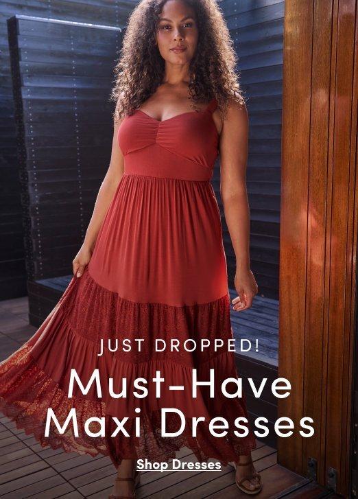 Model wearing a sleeveless floral maxi dress with a mixed print border, styled with white ankle boots. Text reads, “Trending: Boot + Dress All Season!” with a “Shop Dresses” call to action.