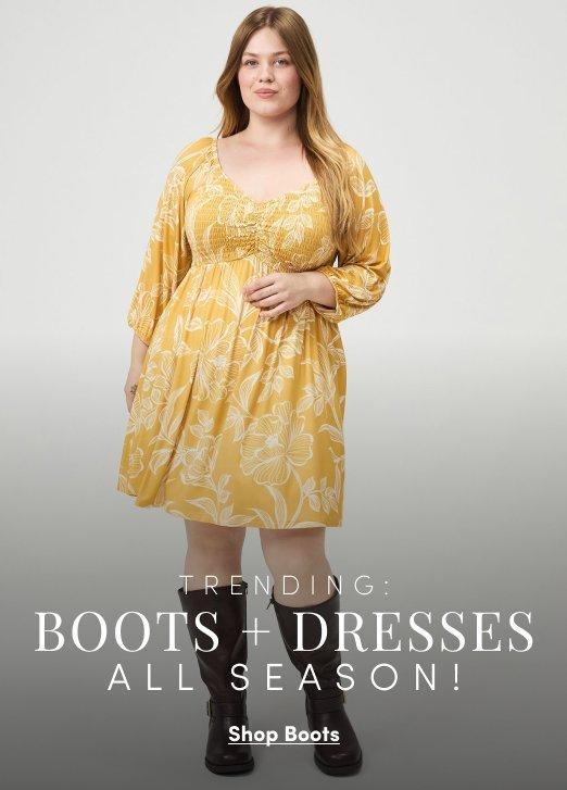 Model wearing a mustard yellow floral mini dress with three-quarter sleeves and black knee-high boots. Text reads, “Trending: Boots + Dresses All Season!” with a “Shop Boots” call to action.